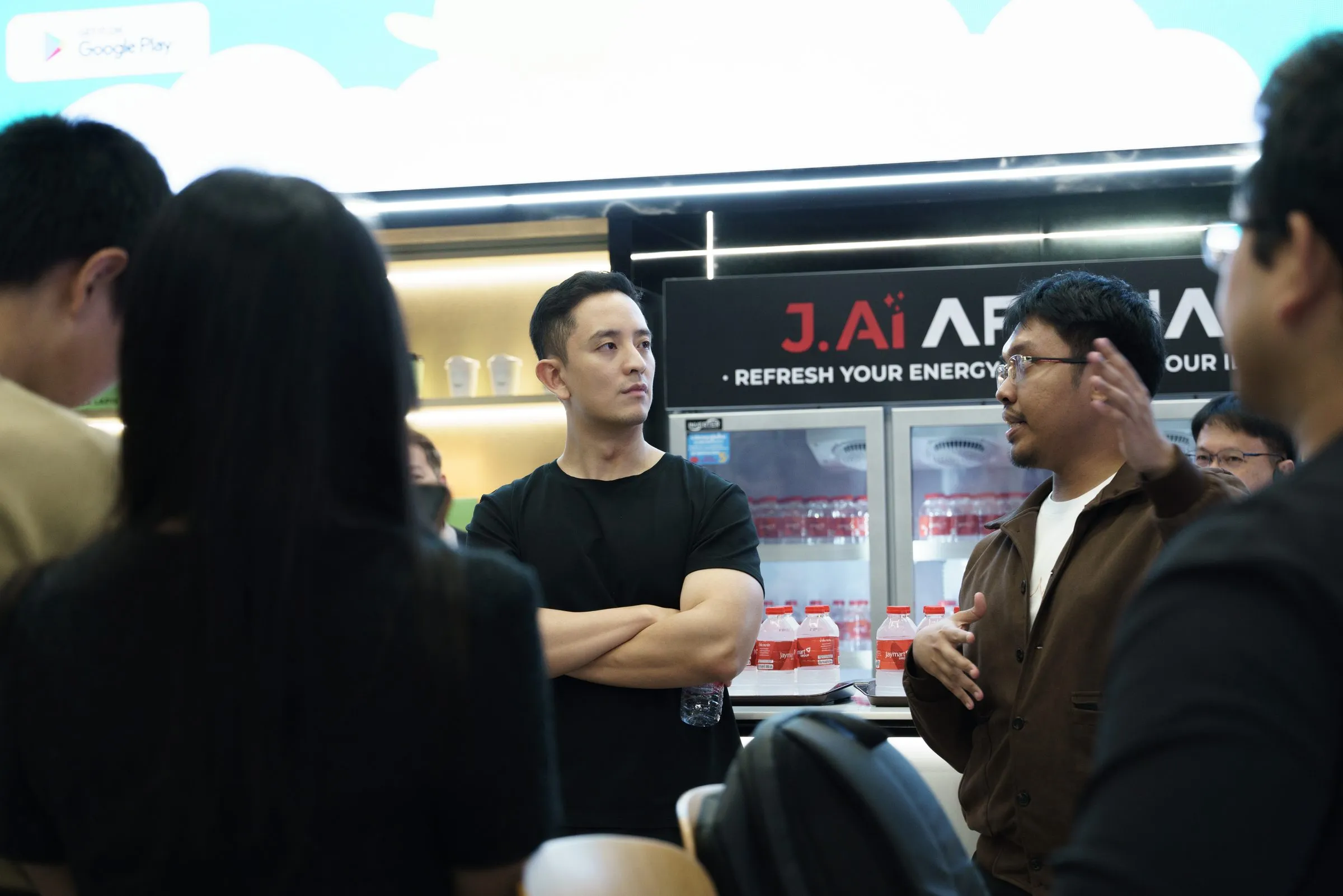 Attendees talking in the networking area beside the J.AI Arena bar